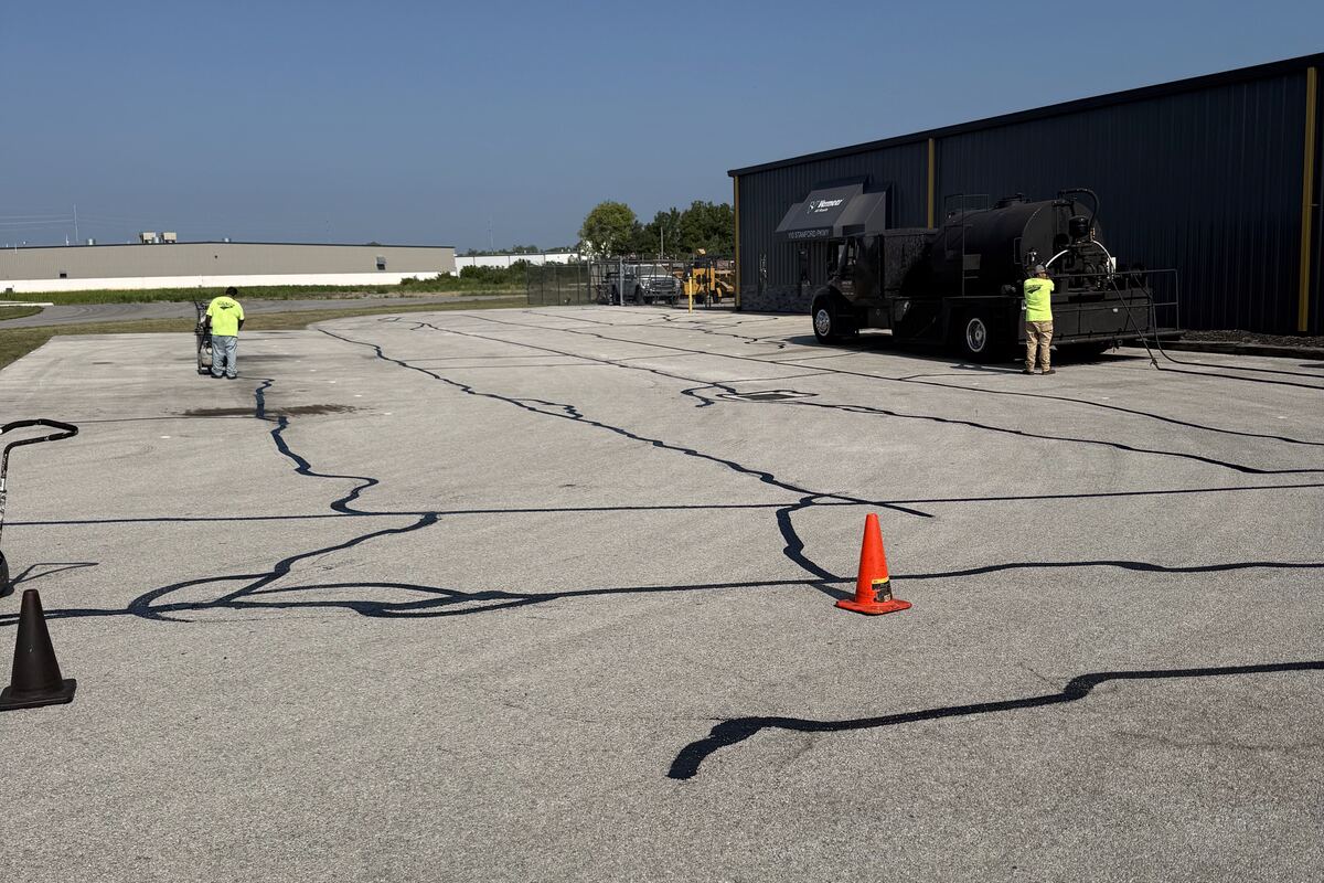 SealTek crew hot-applying CrackMaster rubberized crack filler to asphalt pavement in Findlay, Ohio